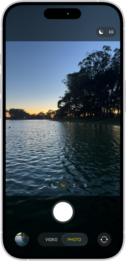 The Camera screen in Photo mode. Within the viewfinder is a night scene. Buttons for Night and Camera Controls mode appear in the top-right corner of the screen. At the bottom of the screen are, from left to right, the Photo and Video Viewer button, Video and Photo Mode, and the Camera Chooser Back-Facing button.