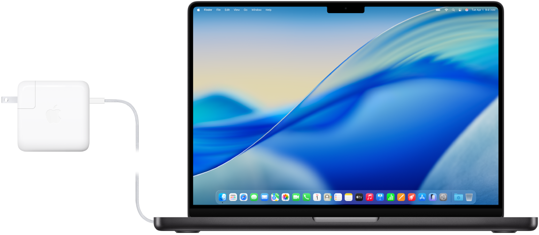 A 14-inch MacBook Pro with the power adapter attached.