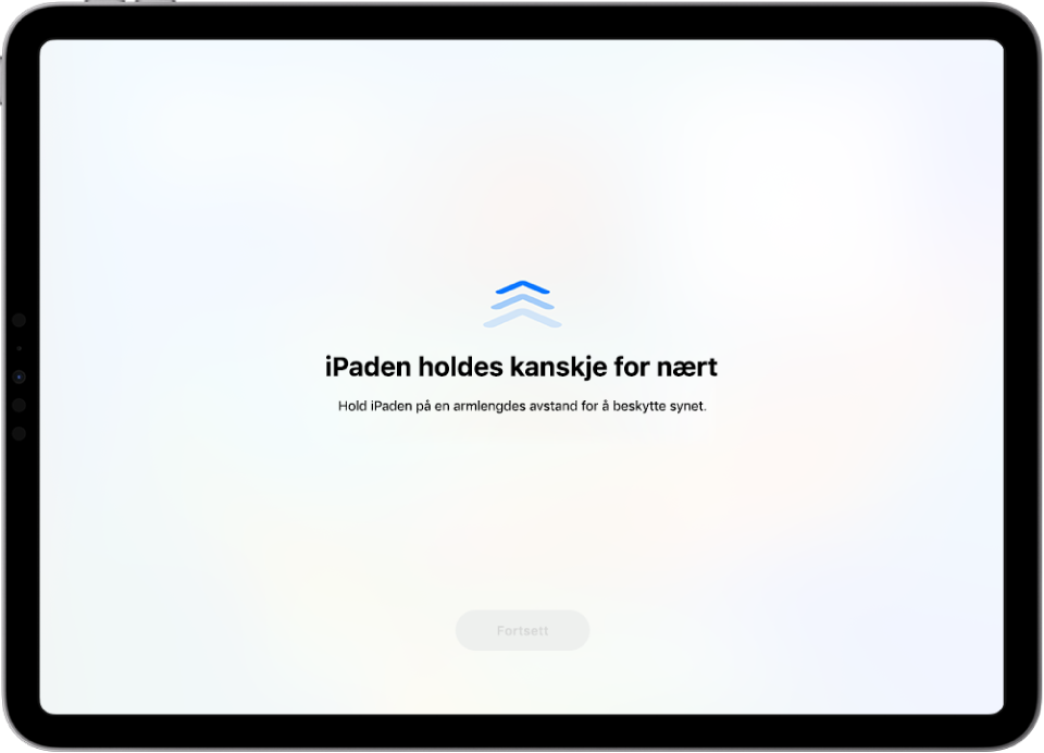 Det vises en advarsel på skjermen om at du holder iPaden for nærme og at du må holde den lenger unna for å beskytte øynene dine. Advarselen dekker hele skjermen og hindrer deg i å fortsette å bruke enheten. Fortsett-knappen blir tilgjengelig når du har flyttet iPaden til en trygg avstand.