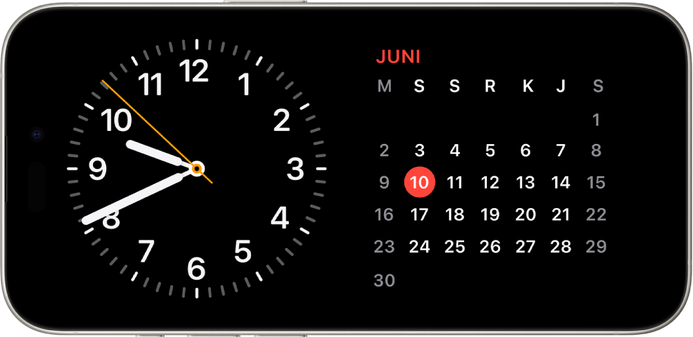 iPhone diputar secara horizontal. Sisi kiri layar menampilkan jam dan sisi kanan layar menampilkan tanggal.