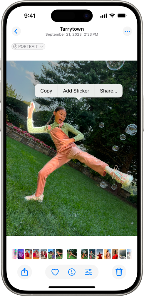 The Photos app is open to a photo of a person. The person is selected, and the option Add Sticker is available in the menu above.