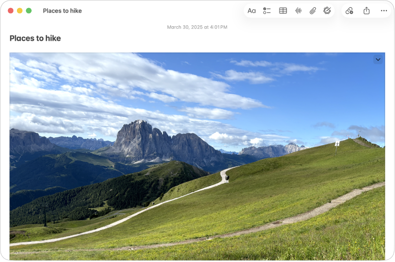 A Notes app window on Mac showing a note that includes a large photo of a hill and mountains.