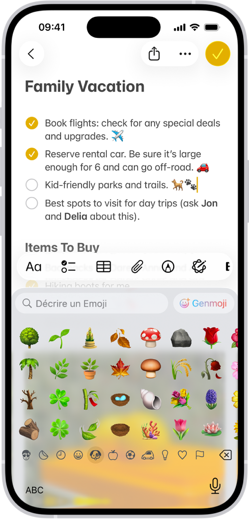 Une note est ouverte dans l’app Notes dans la moitié supérieure de l’écran et le clavier des Emoji est ouvert dans la moitié inférieure.