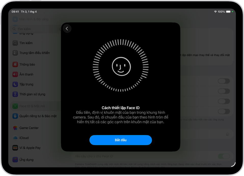 Màn hình thiết lập nhận dạng Face ID. Một khuôn mặt cười đang hiển thị trên màn hình, được bao quanh trong một vòng tròn. Văn bản bên dưới hướng dẫn người dùng di chuyển chậm đầu của họ để hoàn thành vòng tròn. Một nút cho Bắt đầu xuất hiện gần cuối màn hình.