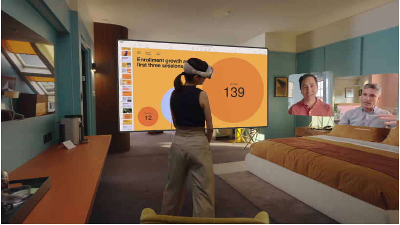 A person wearing Apple Vision Pro and having a FaceTime call. The tiles for others on the call are visible next to a shared screen.