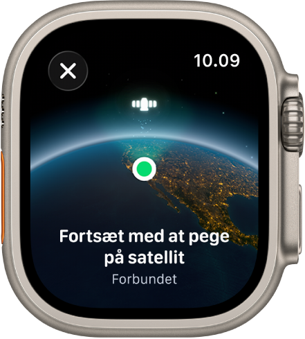 En skærm med et satellitsymbol over et buet billede af Jorden, en grøn indikator for forbindelse og teksten ”Fortsæt med at pege på satellit”.