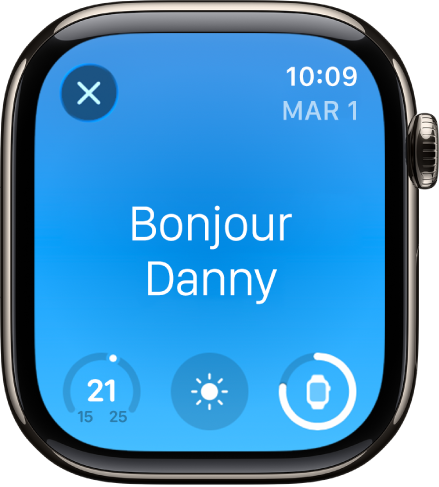 L’Apple Watch affichant l’écran de réveil. Le mot « Bonjour » apparaît en haut. La température, la météo et le niveau de la batterie s’affichent en dessous.
