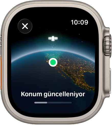 “Konum güncelleniyor” ifadesiyle birlikte bir ilerleme çubuğunu ve yeşil konum göstergesi noktasıyla uzaydan Dünya görünümünü gösteren bir ekran.