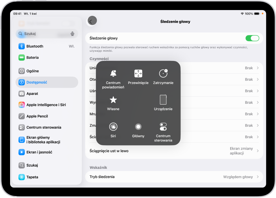 iPad z włączonym śledzeniem ruchów głowy. Widoczne jest menu funkcji AssistiveTouch, zawierające narzędzia: Centrum powiadomień, Przewiń, Zatrzymanie, Urządzenie, Centrum sterowania, Główny, Siri oraz Własne.