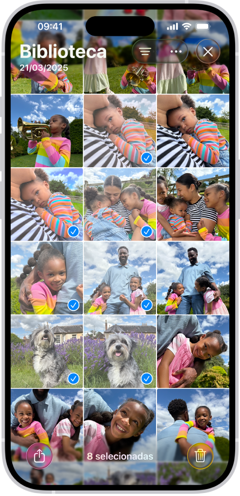 O ecrã do iPhone está preenchido com uma grelha de fotografias, algumas das quais estão selecionadas. Na parte inferior do ecrã estão os botões “Partilhar” e “Apagar”.