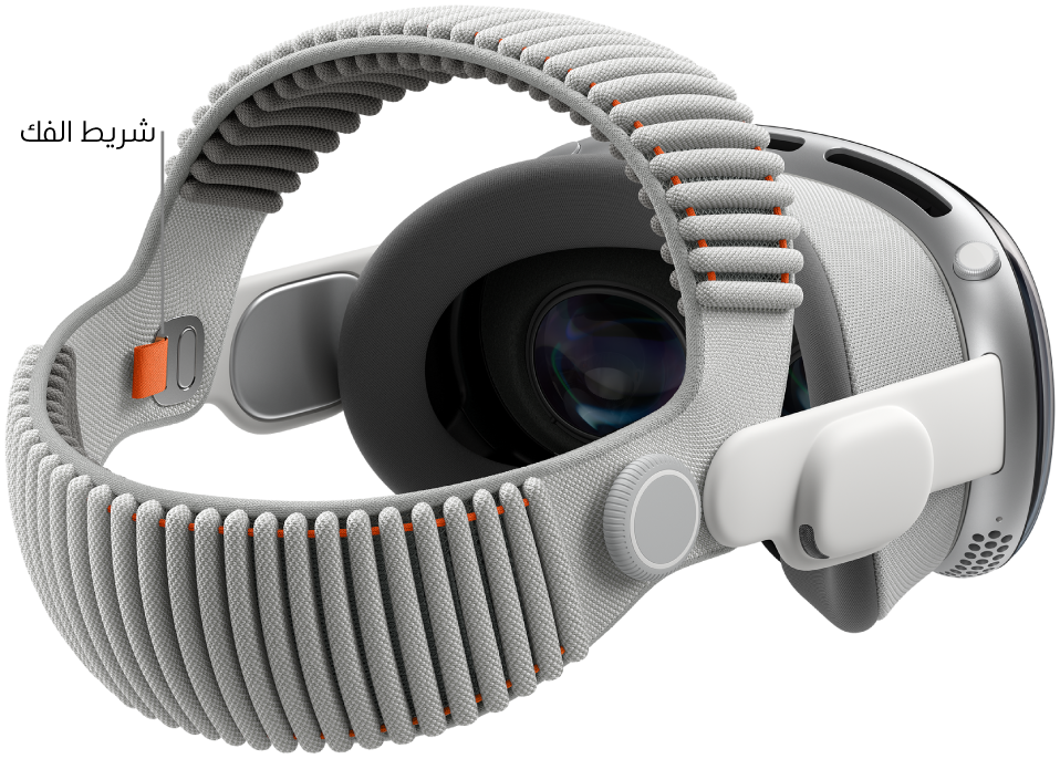 Apple Vision Pro ملحق بها الحزام الثنائي المغزول. يظهر لسان تحرير برتقالي على الجانب الداخلي من الحزام الثنائي المغزول.