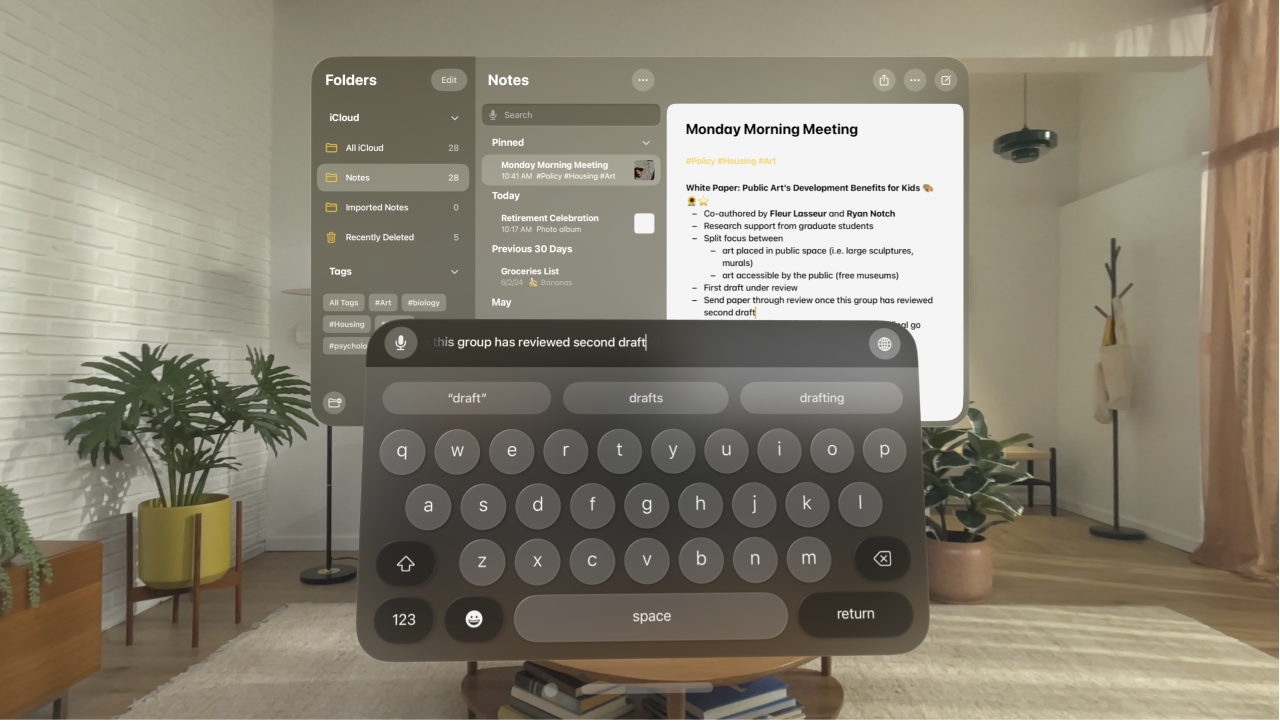 A user’s view on Apple Vision Pro. The Notes app is open, and a note is being edited with the virtual keyboard. The preview of the text being edited is visible at the top of the keyboard.