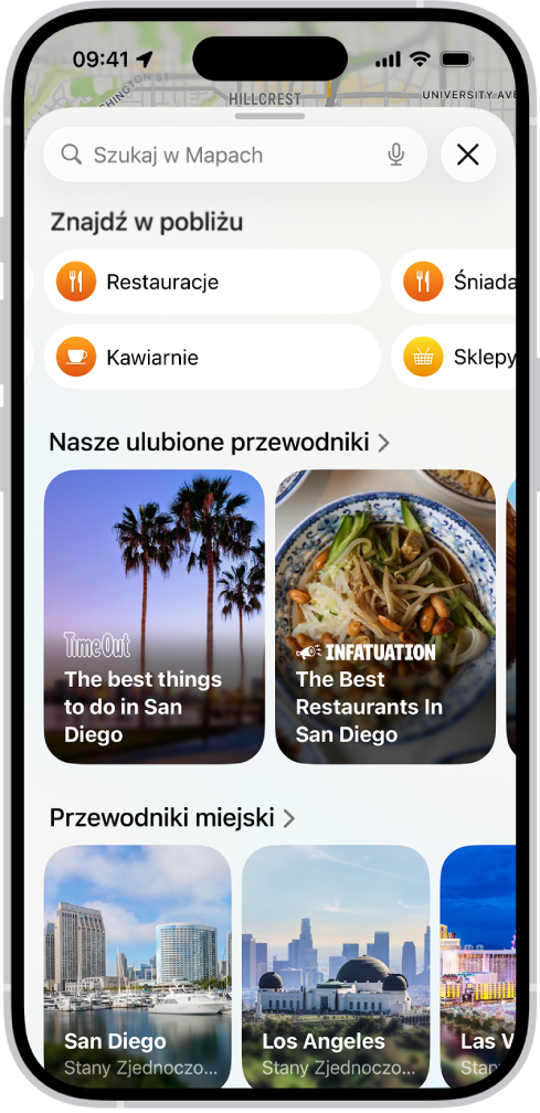 Aplikacja Mapy wyświetlająca pole wyszukiwania, kategorie pobliskich usług oraz przewodniki po mieście. W dolnej części ekranu widoczna jest klawiatura ekranowa iPhone’a.