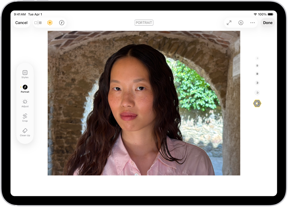 The Edit screen of a Portrait mode photo. The photo is in the center of the screen and on the right side of the screen are the Portrait Lighting effect options. Stage Light is selected and there is a slider to adjust the level of the effect. On the left side of the screen are the Portrait, Adjust, Filters, and Crop buttons. The Portrait button is selected.