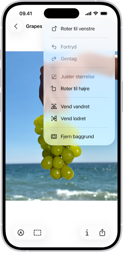 En skærm, der viser et billede med vindruer i forgrunden. En menu, der viser indstillingen Fjern baggrund. Nederst på skærmen er knapperne Markering, Beskær, Info og Del.