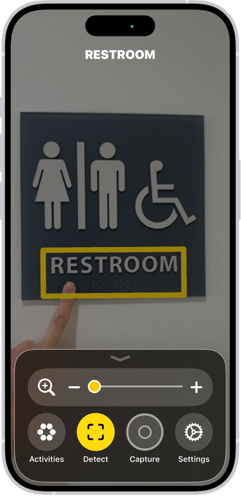 The Magnifier app detecting a finger pointing at text on a wall.