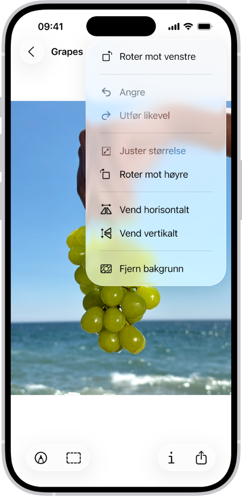 En skjerm som viser et bilde med druer i forgrunnen. En meny viser Fjern bakgrunn-valget. Nederst på skjermen vises knappene Merking, Beskjær, Info og Del.