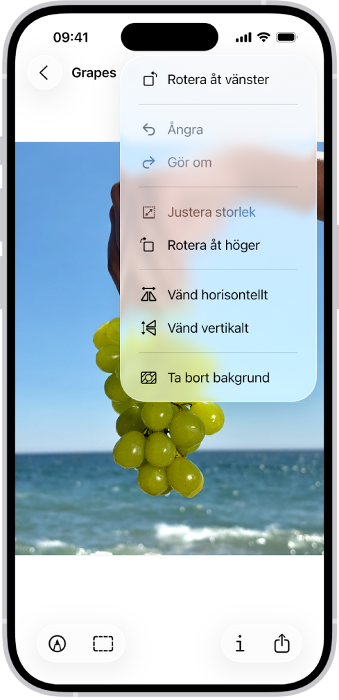 En skärm visar en bild med vindruvor i förgrunden. En meny visar alternativet Ta bort bakgrund. Längst ned på skärmen finns knapparna Märkning, Beskär, Info och Dela.
