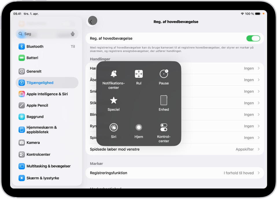 En iPad med registrering af hovedbevægelse slået til. Menuen AssistiveTouch er synlig og viser betjeningsmuligheder til Notifikationscenter, Rul, Pause, Enhed, Kontrolcenter, Hjem, Siri og Speciel.
