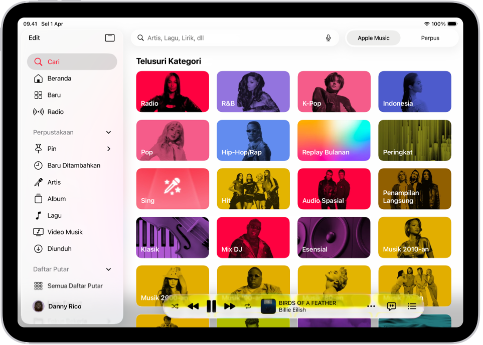 Tab Cari menampilkan bar samping di sebelah kiri dan bidang pencarian di kanan atas. Di bawah bidang pencarian, berbagai kategori musik muncul. MiniPlayer berada di bagian bawah.
