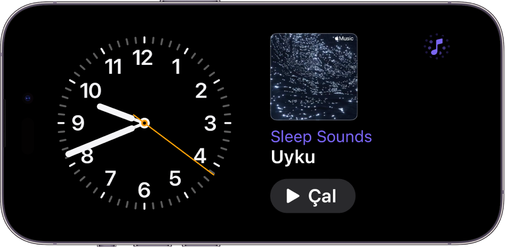 Saat araç takımını ve Ambiyans Müziği araç takımını gösteren iPhone Bekleme Modu ekranı