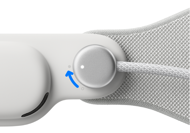 Apple Vision Pro with the power cable attached to the left Audio Strap. The cable is rotated clockwise to lock it in place.