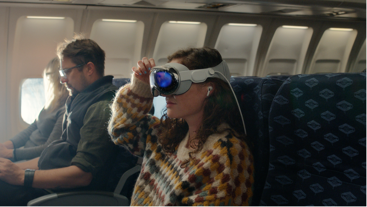 A person wearing Apple Vision Pro with AirPods Pro in their ears.