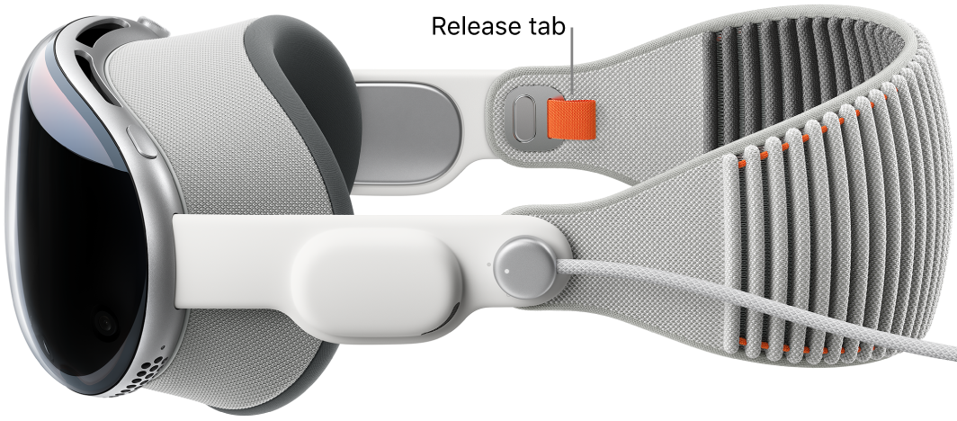 Apple Vision Pro with the Solo Knit Band attached. An orange release tab is visible on the inside of the Solo Knit Band.