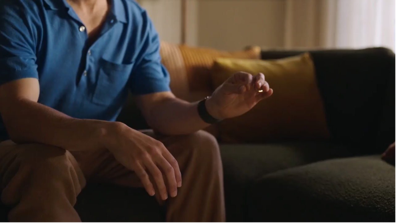 A person tapping their index finger and thumb together to select something on Apple Vision Pro.