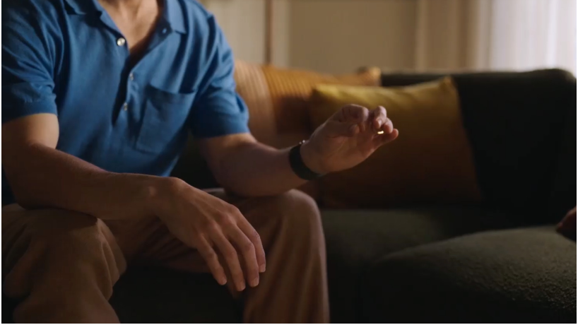 A person tapping their index finger and thumb together to select something on Apple Vision Pro.
