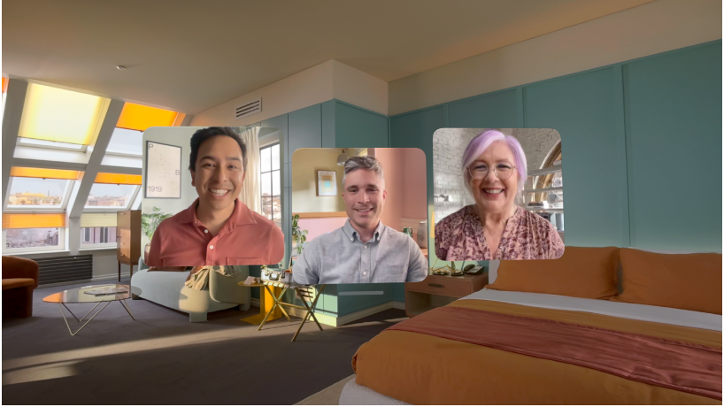 Appel FaceTime sur l’Apple Vision Pro, affichant trois vignettes d’autres participants superposées à la pièce de l’utilisateur.