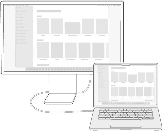 Egy MacBook Airhez csatlakoztatott kijelző. Az íróasztal mindkét képernyőre tükrözve van.