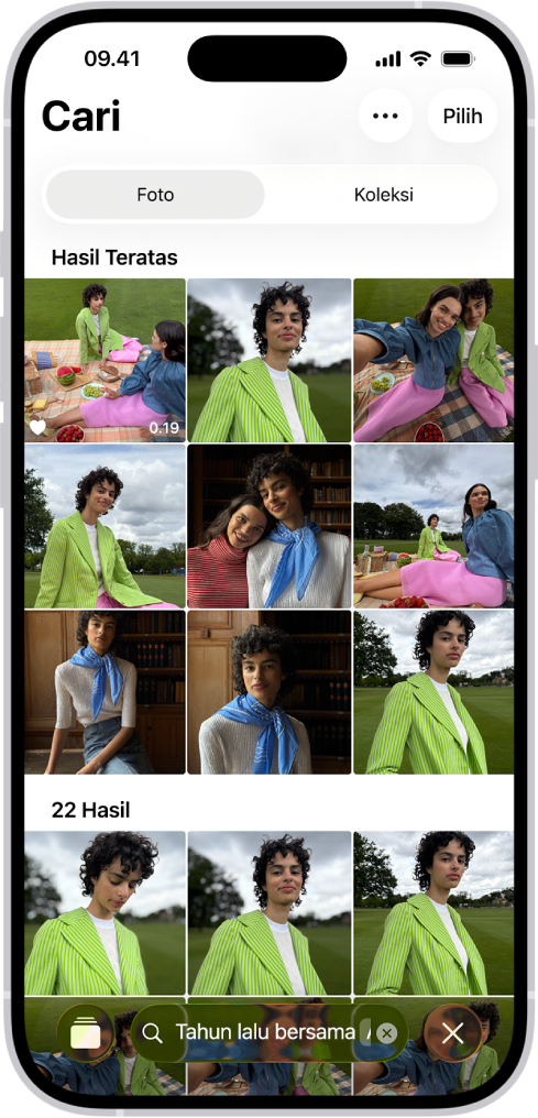 iPhone menampilkan foto di app Foto. Bar pencarian dengan deskripsi muncul di bagian bawah layar.