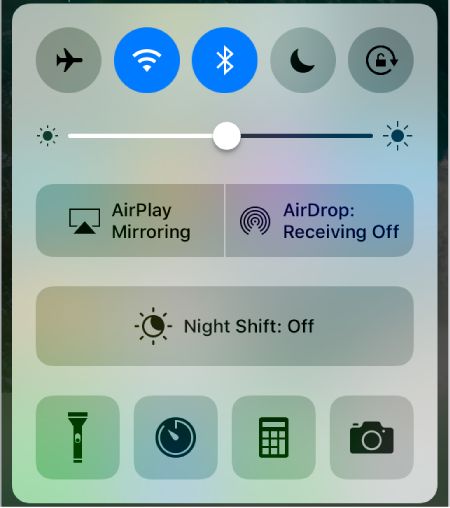 The Control Center screen. In the top row are the Airplane mode, Wi-Fi, Bluetooth, Do Not Disturb, and Lock Orientation buttons. Below that is the screen brightness control. Below that is Now Playing info with audio playback controls. Below that are the AirDrop and AirPlay buttons. At the bottom are the Flashlight, Clock, Calculator, and Camera buttons.