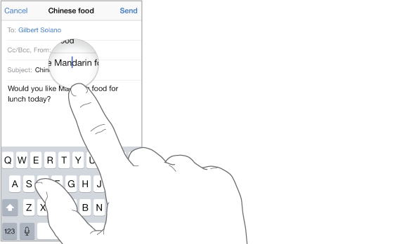 Finger touching the screen to get a magnified view of text and the insertion point.